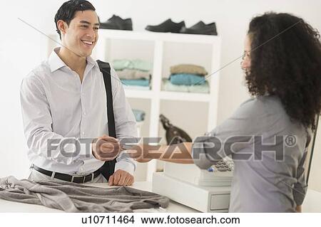 Picture - Customer and sales clerk in store. Fotosearch
