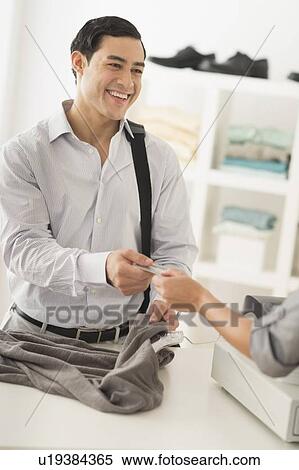 Stock Photography - Customer and sales clerk in store. Fotosearch
