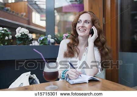 Elegant woman in cafe using mobile phone View Large Photo Image Stock Image - Elegant woman in cafe using mobile phone. Fotosearch