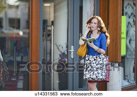 Elegant woman walking street and talking on mobile phone View Large Photo Image Stock Image - Elegant woman walking street and talking on mobile phone. Fotosearch