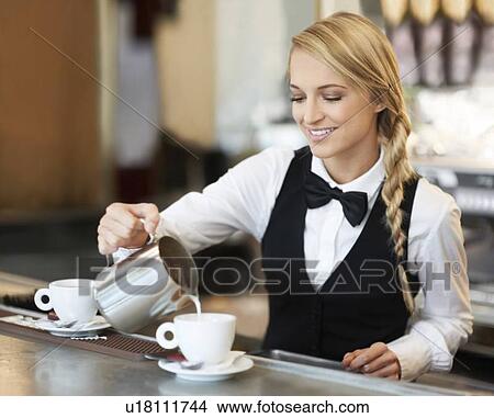 Female barista pouring milk into coffee cup View Large Photo Image Picture - Female barista pouring milk into coffee cup. Fotosearch