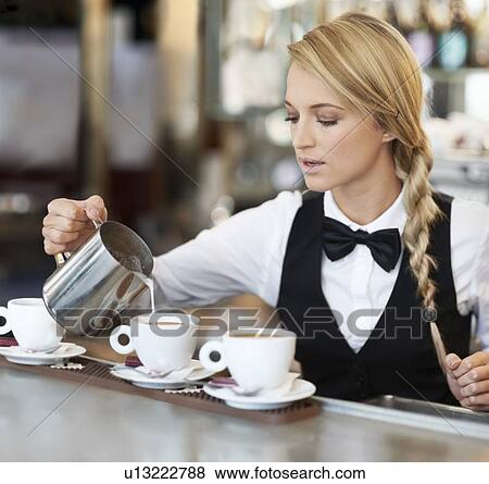 Female barista pouring milk into coffee cup View Large Photo Image Stock Photo - Female barista pouring milk into coffee cup. Fotosearch