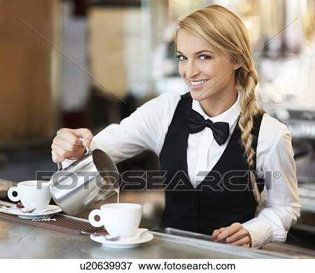 Female barista pouring milk into coffee cup View Large Photo Image Stock Photo - Female barista pouring milk into coffee cup. Fotosearch