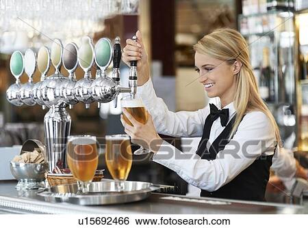 Female bartender pouring beer View Large Photo Image Stock Photograph - Female bartender pouring beer. Fotosearch
