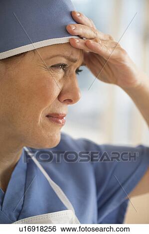 Female surgeon suffering headache View Large Photo Image Stock Photograph - Female surgeon suffering headache. Fotosearch