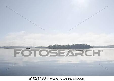 Picture - Fishing boat on lake. Fotosearch