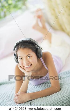 Front view of teenage girl ( 16-17 years) with headphones View Large Photo Image Stock Photo - Front view of teenage girl ( 16-17 years) with headphones. Fotosearch