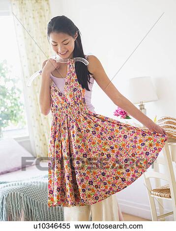 Front view of teenage girl ( 16-17 years) trying on dress View Large Photo Image Stock Photography - Front view of teenage girl ( 16-17 years) trying on dress. Fotosearch