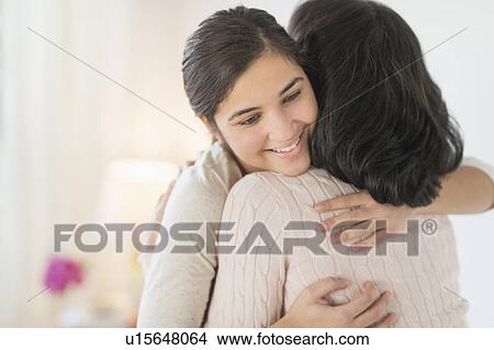 Picture - Grandmother and granddaughter (16-17) embracing. Fotosearch
