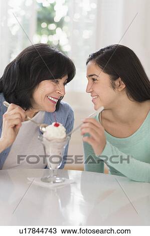 Grandmother and granddaughter (16-17) sharing ice-cream View Large Photo Image Stock Image - Grandmother and granddaughter (16-17) sharing ice-cream. Fotosearch