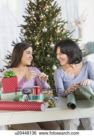 Grandmother and granddaughter (16-17) wrapping christmas gifts View Large Photo Image Stock Photograph - Grandmother and granddaughter (16-17) wrapping christmas gifts. Fotosearch