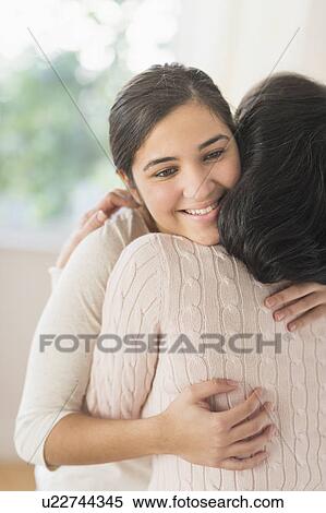 Stock Photography - Grandmother and granddaughter (16-17) embracing. Fotosearch
