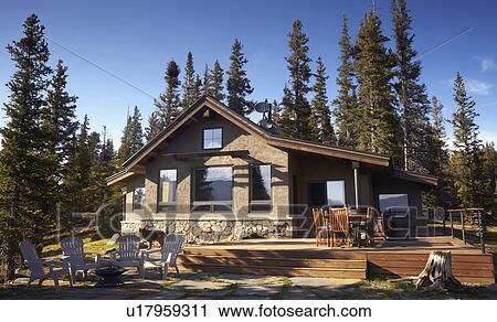Stock Image - House in forest. Fotosearch