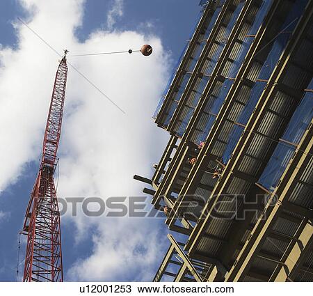 Low angle view of crane and building under construction View Large Photo Image Stock Image - Low angle view of crane and building under construction. Fotosearch