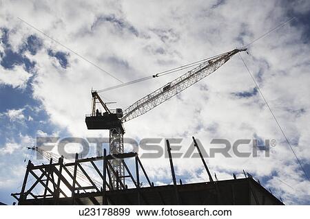 Low angle view of crane at building site View Large Photo Image Stock Photo - Low angle view of crane at building site. Fotosearch