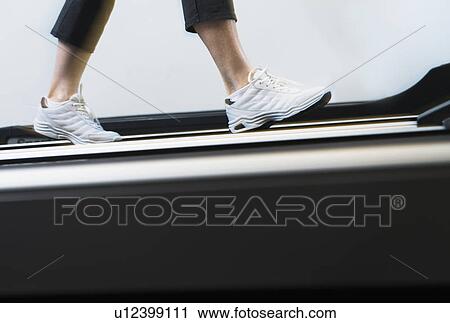 Low section of woman on treadmill View Large Photo Image Stock Image - Low section of woman on treadmill. Fotosearch