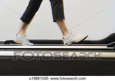 Low section of woman on treadmill View Large Photo Image Stock Image - Low section of woman on treadmill. Fotosearch