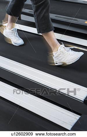Stock Photo - Low section of woman on treadmill. Fotosearch