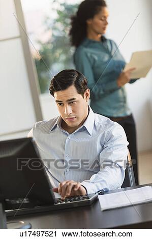 Man and woman working in office View Large Photo Image Stock Image - Man and woman working in office. Fotosearch