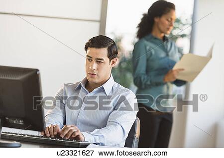 Man and woman working in office View Large Photo Image Stock Photo - Man and woman working in office. Fotosearch