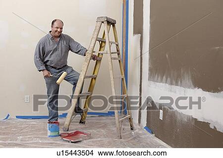 Man painting wall View Large Photo Image Picture - Man painting wall. Fotosearch