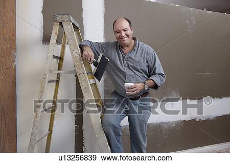 Man painting wall View Large Photo Image Stock Photo - Man painting wall. Fotosearch