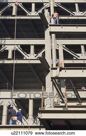 Men working on construction frame View Large Photo Image Stock Photo - Men working on construction frame. Fotosearch