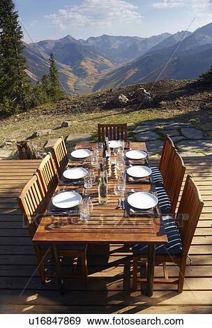 Outdoor table and chairs on wooden terrace View Large Photo Image Stock Photo - Outdoor table and chairs on wooden terrace. Fotosearch