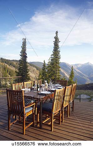 Outdoor table and chairs on wooden terrace View Large Photo Image Stock Photograph - Outdoor table and chairs on wooden terrace. Fotosearch