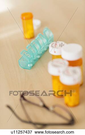 Stock Photo - Pills on table. Fotosearch
