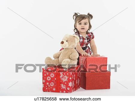 Portrait of Baby girl ( 6-11 months) with gift boxes View Large Photo Image Stock Photo - Portrait of Baby girl ( 6-11 months) with gift boxes. Fotosearch