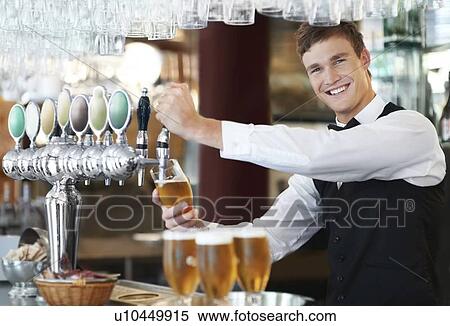 Stock Photography - Portrait of bartender pouring beer. Fotosearch