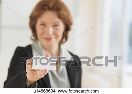 Portrait of businesswoman holding blank business card View Large Photo Image Picture - Portrait of businesswoman holding blank business card. Fotosearch