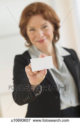 Portrait of businesswoman holding blank business card View Large Photo Image Stock Photo - Portrait of businesswoman holding blank business card. Fotosearch