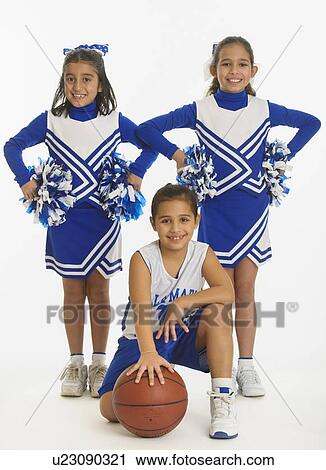 Portrait of cheerleaders (8-9 years) ( 10-11 years) holding pom-pom and ball View Large Photo Image Stock Image - Portrait of cheerleaders (8-9 years) ( 10-11 years) holding pom-pom and ball. Fotosearch