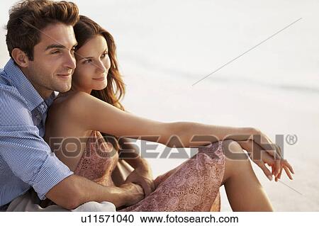 Portrait of couple hugging on beach View Large Photo Image Stock Image - Portrait of couple hugging on beach. Fotosearch