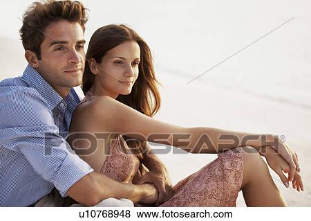 Portrait of couple hugging on beach View Large Photo Image Stock Photo - Portrait of couple hugging on beach. Fotosearch