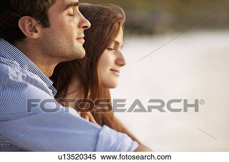 Portrait of couple hugging on beach View Large Photo Image Stock Photography - Portrait of couple hugging on beach. Fotosearch