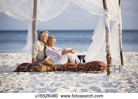 Stock Image - Portrait of couple on beach. Fotosearch