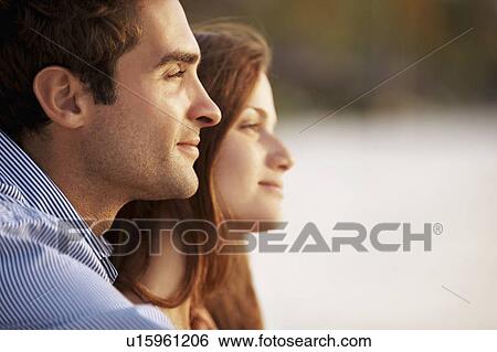 Stock Photograph - Portrait of couple on beach. Fotosearch