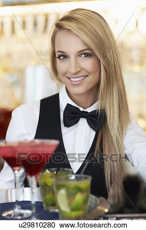 Portrait of female bartender holding tray with cocktails View Large Photo Image Stock Image - Portrait of female bartender holding tray with cocktails. Fotosearch