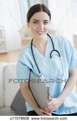 Stock Photo - Portrait of female doctor in hospital uniform. Fotosearch