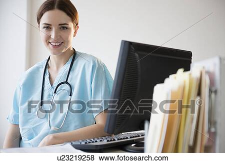 Stock Photo - Portrait of female doctor in hospital uniform. Fotosearch