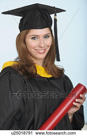 Stock Image - Portrait of graduate student holding diploma. Fotosearch