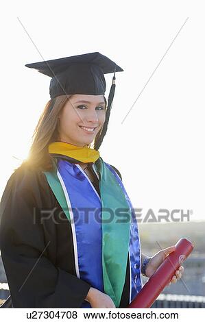 Portrait of graduate student holding diploma View Large Photo Image Stock Photo - Portrait of graduate student holding diploma. Fotosearch