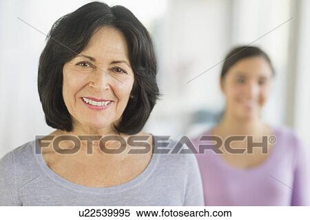 Stock Photography - Portrait of grandmother and granddaughter (16-17). Fotosearch