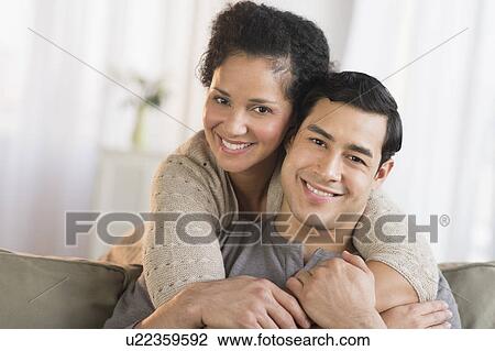 Stock Image - Portrait of happy couple embracing. Fotosearch