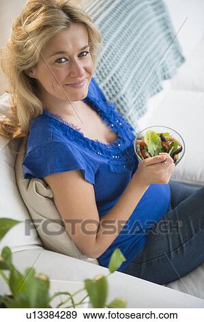 Stock Photo - Portrait of pregnant woman having salad. Fotosearch