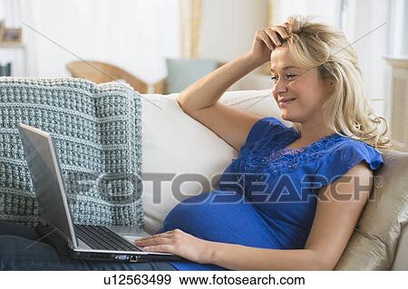 Portrait of pregnant woman using laptop View Large Photo Image Stock Photo - Portrait of pregnant woman using laptop. Fotosearch