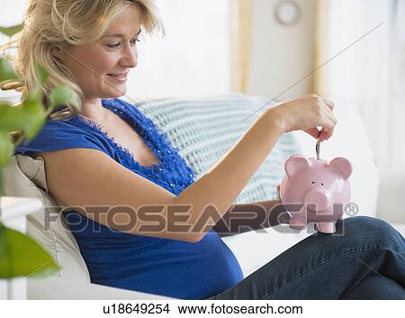 Portrait of pregnant woman with piggy bank View Large Photo Image Picture - Portrait of pregnant woman with piggy bank. Fotosearch